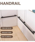 Heavy Duty Black Wrought Iron Stair Railing With Sick Super Grippy Treads For Indoor Outdoor All Weather Home Safety No Sweat Mount For Attic Porch Deck shown installed in an indoor setting.