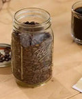 Real Deal Wide Mouth Glass Mason Jars With Lids And Bands For Canning And Pickling Quart 32 Oz Pack Of 2 Featuring Tight Airtight Seals and Durable BPA Free Glass Storage with coffee beans.