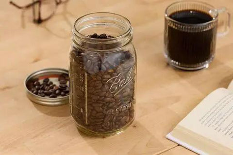 Real Deal Wide Mouth Glass Mason Jars With Lids And Bands For Canning And Pickling Quart 32 Oz Pack Of 2 Featuring Tight Airtight Seals and Durable BPA Free Glass Storage with coffee beans.