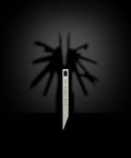 Beefy Heavy Duty Keychain Pry Bar For Everyday Carry in stainless steel, minimalist design casting shadow of multitool features.