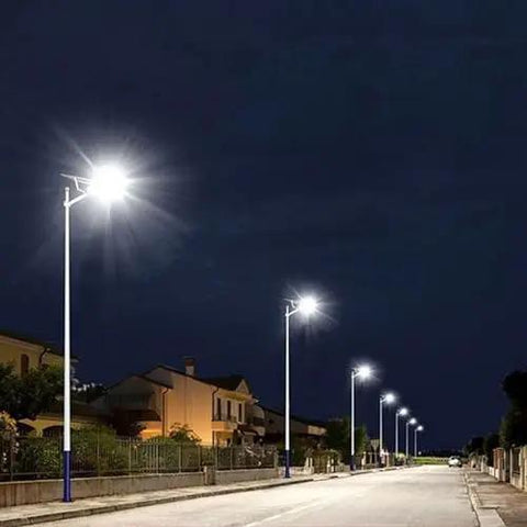 Heavy Duty Solar Street Light With Dang Bright 6000 Lumens And Heckin Wide 320 Degree Coverage Featuring Wireless Remote Plus Dusk To Dawn Auto Mode For Rock Solid Yard And Parking Lot Illumination illuminating a quiet street at night.