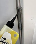 Applying High Performance Penetrating Oil For Bike Chain Lubrication Door Hinges And Locks Rust Removal to a metal door hinge