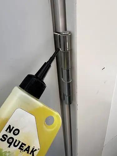 Applying High Performance Penetrating Oil For Bike Chain Lubrication Door Hinges And Locks Rust Removal to a metal door hinge