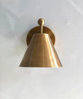 Handcrafted Brass Wall Sconce with Finial Vintage Hardwired Light featuring a cone-shaped brass shade and round finial detail.