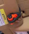 Resqme emergency escape tool clipped to car sun visor; orange 2-in-1 seatbelt cutter and window breaker.