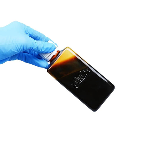 Pro Grade WS2 Dispersion Nano Tungsten Disulfide For Lubrication, Catalysis, Energy Storage And Composite Materials, 200ml, Water Or Ethanol Solvent, Ready To Ship Same Day Priority Shipping in a clear bottle held in a gloved hand.
