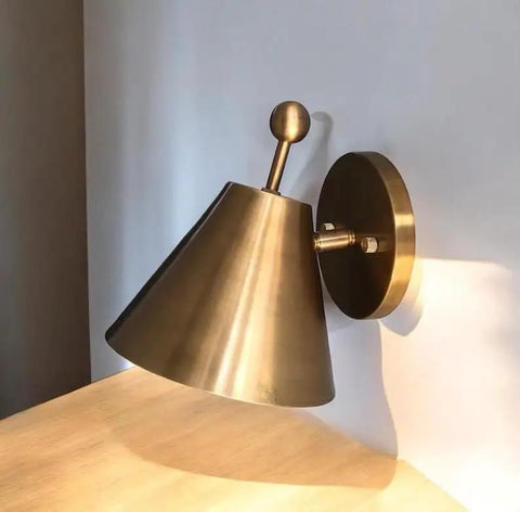 Handcrafted Brass Wall Sconce with Finial Vintage Hardwired Light showcasing conical shade and ball finial against wall.