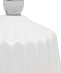 Close-up of the off-white ceramic base of the Petite Pleated Ceramic Table Lamp With Off White Fabric Shade 5 Ft Cord 40W Equivalent Type B Bulb Not Included Classic English Style Accent Light For Bedroom Or Living Room Cozy Glow.