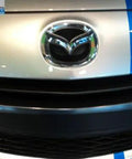 Mazda Front Logo Emblem C235 51 731A Replacement For 2006 2013 Mazda2 Mazda3 Mazda5 And Mazda6 Direct OEM Factory Original Part installed on car