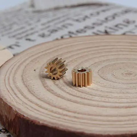 Two Pack Brass Spur Gears, 0.5 Modulus, 12 Teeth, 3mm Bore, 5mm Gear Width on wooden surface.