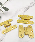 Five Pcs Brushed Brass Deco Furniture Hinges Set Versatile Miniature Door Hinges flat lay view on marble surface