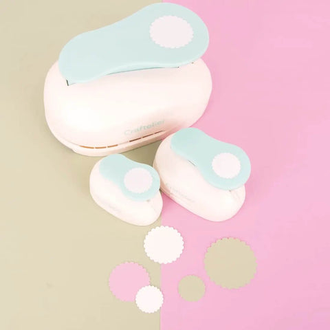 Three sizes of 3 Inch Circle Scallop Punch With Easy Lever Press, shown against a pink and green background with scalloped cutouts.