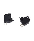 Close-up of black micro switches with metal prongs, used in various electronic applications.