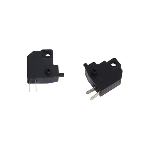 Close-up of black micro switches with metal prongs, used in various electronic applications.