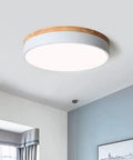 Dimmable Wood Flush Mount Ceiling Light With Round Minimalist Design Five Color Temperatures 2700K To 6000K in a modern bedroom