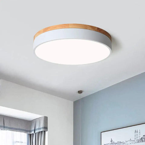 Dimmable Wood Flush Mount Ceiling Light With Round Minimalist Design Five Color Temperatures 2700K To 6000K in a modern bedroom