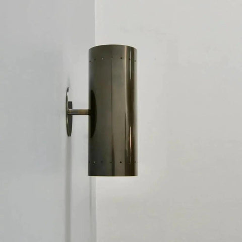 Perforated Brass Wall Sconce - Modern Cylinder Lamp, sleek cylindrical design mounted on white wall.