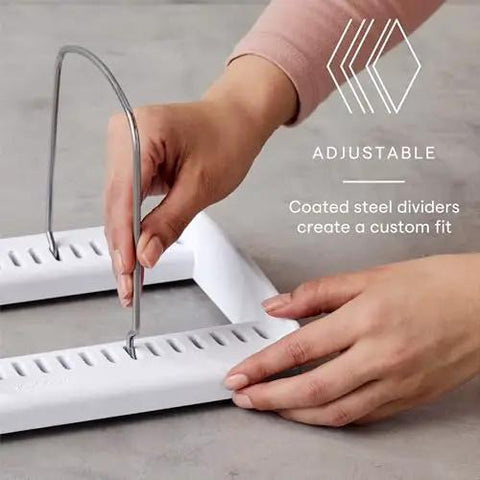 Hands adjusting steel divider on StoreMore Adjustable Bakeware Rack With Steel Wires Seven Adjustable Dividers in kitchen setting.