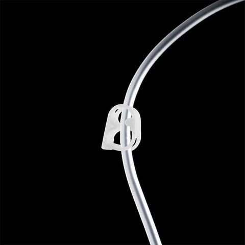 White Plastic Flow Control Tube Clamps Pack For One Quarter To Five Sixteenth Inch Tubing Adjustable Hose Pinch Valves close-up on black background