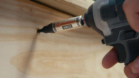 Apex Vortex Bit Holder One Quarter Inch Hex Shank Three And A Half Inch Length in use with an impact driver on wood surface