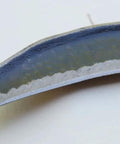 Close-up of the sharp edge of an Austrian-made hand scythe with an 11 inch blade for harvesting grass and weeds reaping sickle style