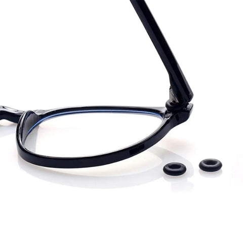 Five Pair Eyeglass Hinge Tightener Rings With Precision Driver To Lock Your Specs Down And Stop Constant Slipping Durable Silicone Anti Slip Sleeve Kit next to black eyeglass frame.