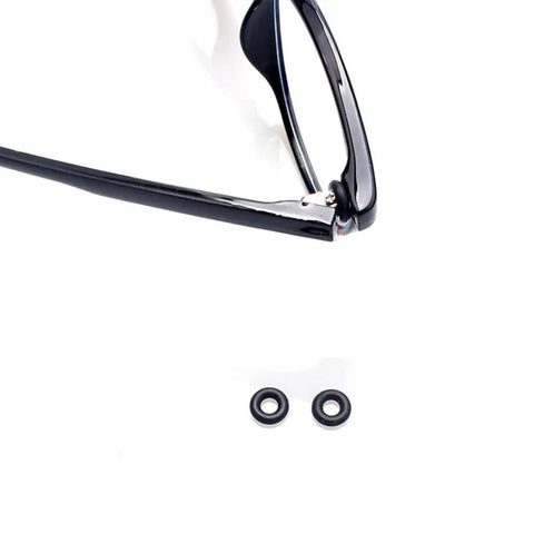 Five Pair Eyeglass Hinge Tightener Rings With Precision Driver To Lock Your Specs Down And Stop Constant Slipping Durable Silicone Anti Slip Sleeve Kit. Close-up of black eyeglasses with two silicone hinge rings.