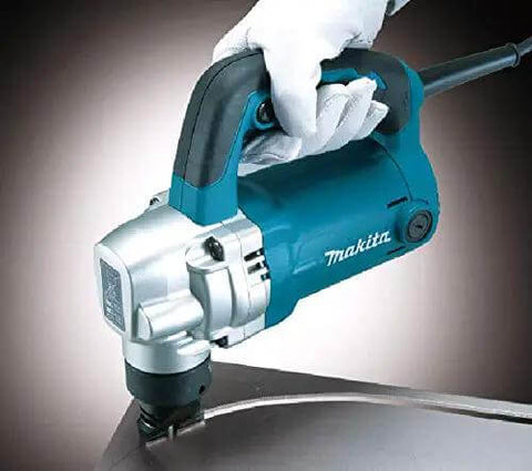 Gloved hand holding Powerful 710W Nibbler With 3.2 mm Capacity, soft grip ergonomic handle, cutting metal with chip clearance from below.