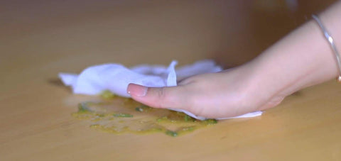Hand using SaniDry Disinfecting Wipes 300 Count EPA Approved Unscented White Nonabrasive Multi Surface Cleaning Wipes to clean spill