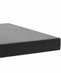 Close-up of the edge of black granite parasol base for square shape umbrellas heavy duty patio umbrella stand for pool deck yard
