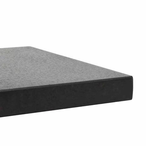 Close-up of the edge of black granite parasol base for square shape umbrellas heavy duty patio umbrella stand for pool deck yard