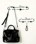 Dope Gold or Black Iron Wall Hook Shelf Decorative Rack for Keys Coats and Hats Perfect for Front Door Entryway to Spice up Your Home with a Trendy Vibe that Slays Every Time with a black bag hanging.