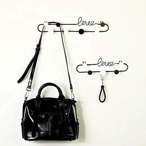 Dope Gold or Black Iron Wall Hook Shelf Decorative Rack for Keys Coats and Hats Perfect for Front Door Entryway to Spice up Your Home with a Trendy Vibe that Slays Every Time with a black bag hanging.