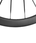 Close-up of Carbon Disc Wheelset 50C Tubeless With Carbon Spokes Thru Axle Center Lock 12x100 Front 12x142 Rear Fits Shimano 8-12 Speed Black