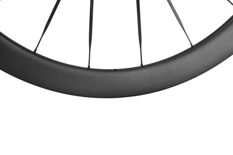 Close-up of Carbon Disc Wheelset 50C Tubeless With Carbon Spokes Thru Axle Center Lock 12x100 Front 12x142 Rear Fits Shimano 8-12 Speed Black
