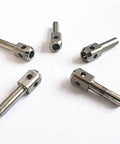 Five stainless steel waterjet poppet pins with drilled holes on white background for waterjet marble cutting machines.