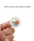 4 Pack White Flexible Rubber Desk Grommets 1 Inch Hole Covers For Cable Management held between fingers