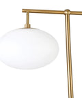 Go To 68 Inch Tall Arc Floor Lamp With Glass Shade In Brushed Brass And Milk White, close-up of milk white glass shade and brass arc.