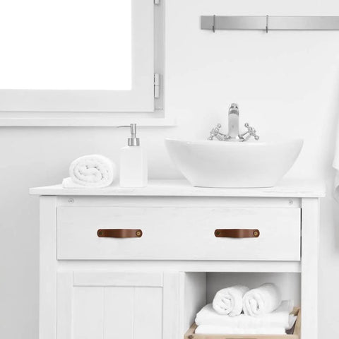 Vanity with Six Piece Leather Drawer Pulls Set In Brown With Gold Rivet Screws, 4.72 Inch Soft Cabinet Dresser Handles in a bathroom setting.