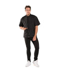 Sleek Black Barber Jacket With Zippered Front And Contrast Pockets Xl Nylon Short Sleeve Top For Salons worn by a man standing with one hand in pocket.