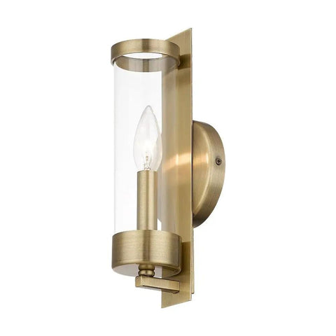 Castleton Antique Brass 1 Light ADA Wall Sconce With Clear Glass Cylinder mounted on wall