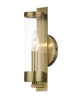 Castleton Antique Brass 1 Light ADA Wall Sconce With Clear Glass Cylinder, side view, showing antique brass and bulb detail.