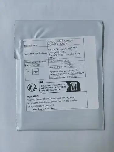 Shipping label on grey package with manufacturer details and safety warning