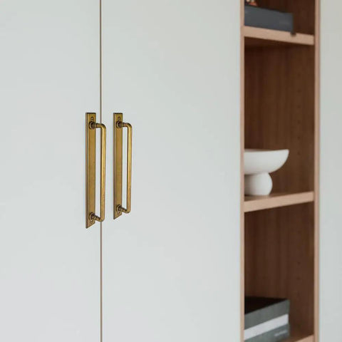 Beefy Antique Brass Cabinet Pulls With Plaquette Backplates, 7 9 16 Inch shown on white cabinet doors