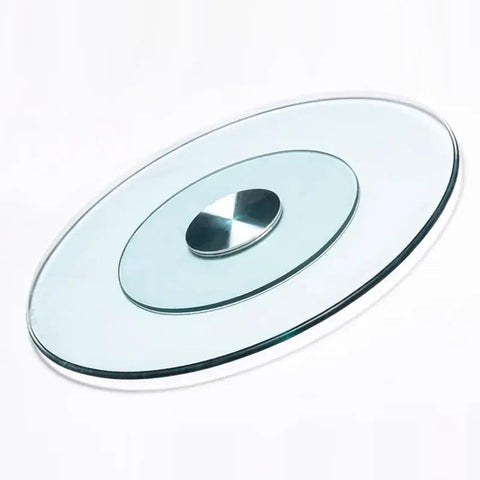 Round Lazy Susan Tempered Glass Turntable Runs Buttery Smooth Heavy Duty Slick Construction Crystal Clear Finish Total Game Changer For Family Dinners And Modern Kitchen Tables 35 To 39 Inches Wide view from above, featuring a sleek glass design with central swivel element.