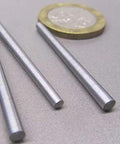 Heavy Duty 18-8 Stainless Steel Taper Pin Set For Precision Machining, 0.125 Inch Large Diameter And 0.094 Inch Small Diameter, 1.50 Inch Long, 10 Piece Pack For Tight Fits, Easy Assembly, And Reliable Alignment shown with a coin for scale.