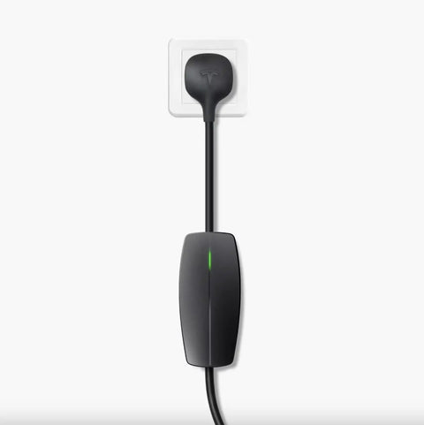 Tesla Mobile Connector Portable EV Charger Level 2 Up To 32 Amps With 20 Ft Cable plugged into a standard outlet.