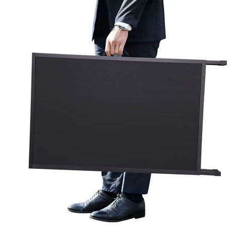 Person carrying the Beefy Heavy Duty Slide In Folding Sandwich Board A Frame Sidewalk Sign 24 By 36 Inch Black Coated Steel.