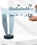 YMGSCC Household 300mm Vernier Caliper held in hand, showcasing stainless steel design, measuring large objects on a table.