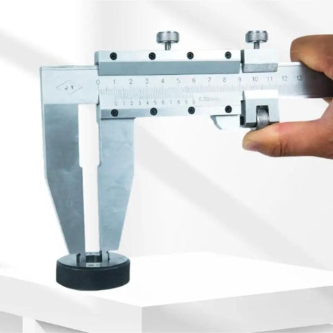 YMGSCC Household 300mm Vernier Caliper held in hand, showcasing stainless steel design, measuring large objects on a table.